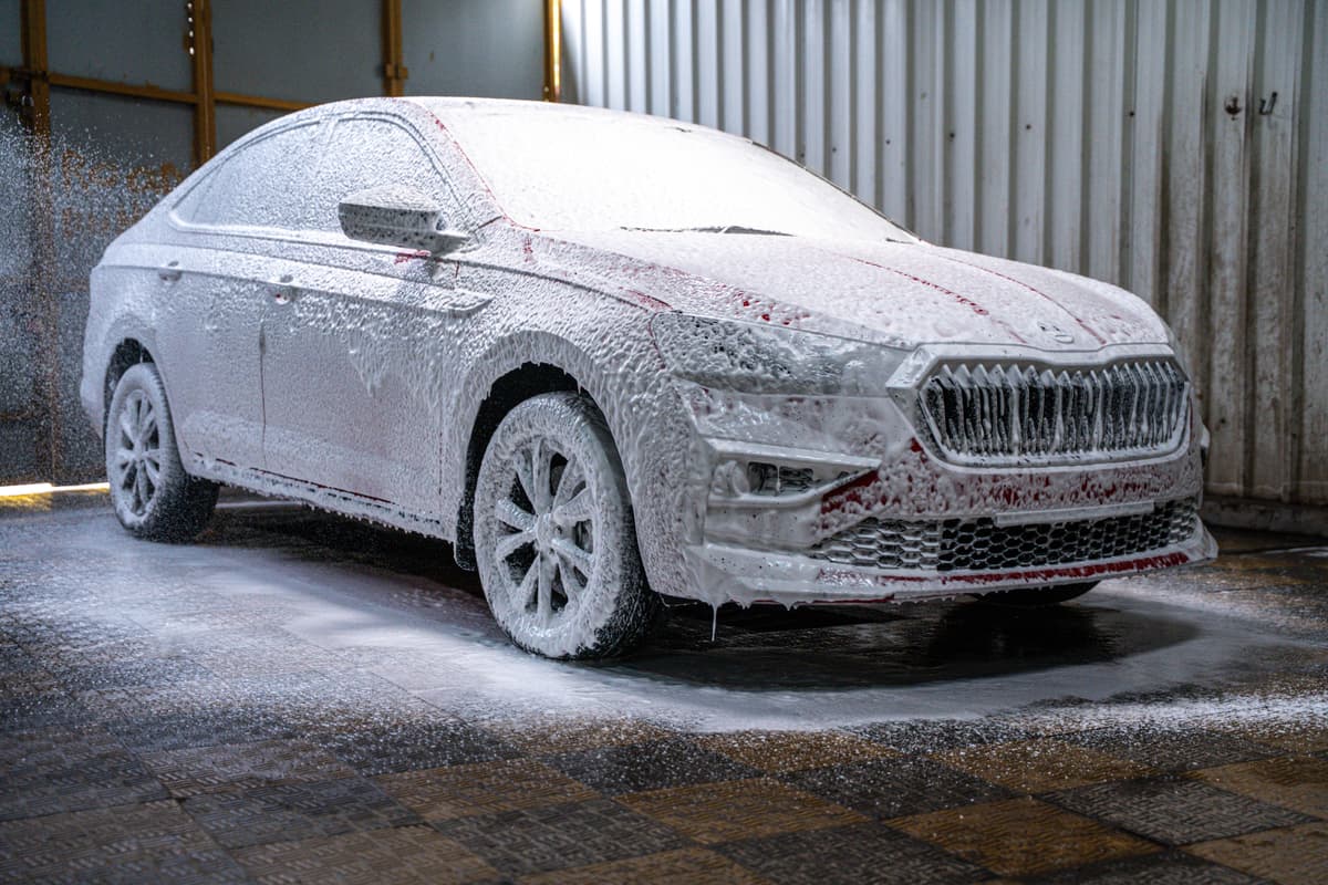 Skoda covered in snow foam during a wash